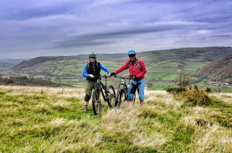 Two mountain bikers out on the Trans Cambrian Way, surrounded by open hills